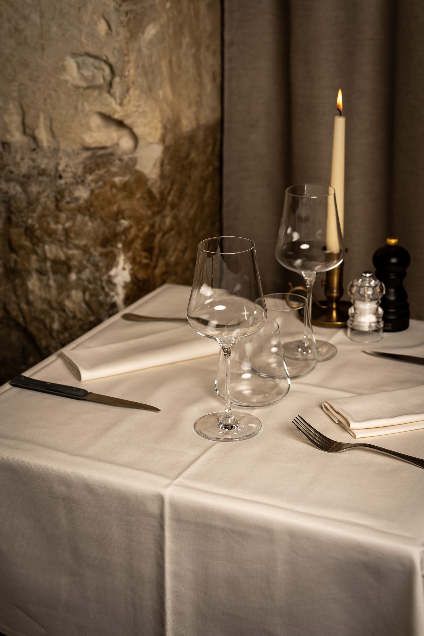 A candlelit table, laid for dinner